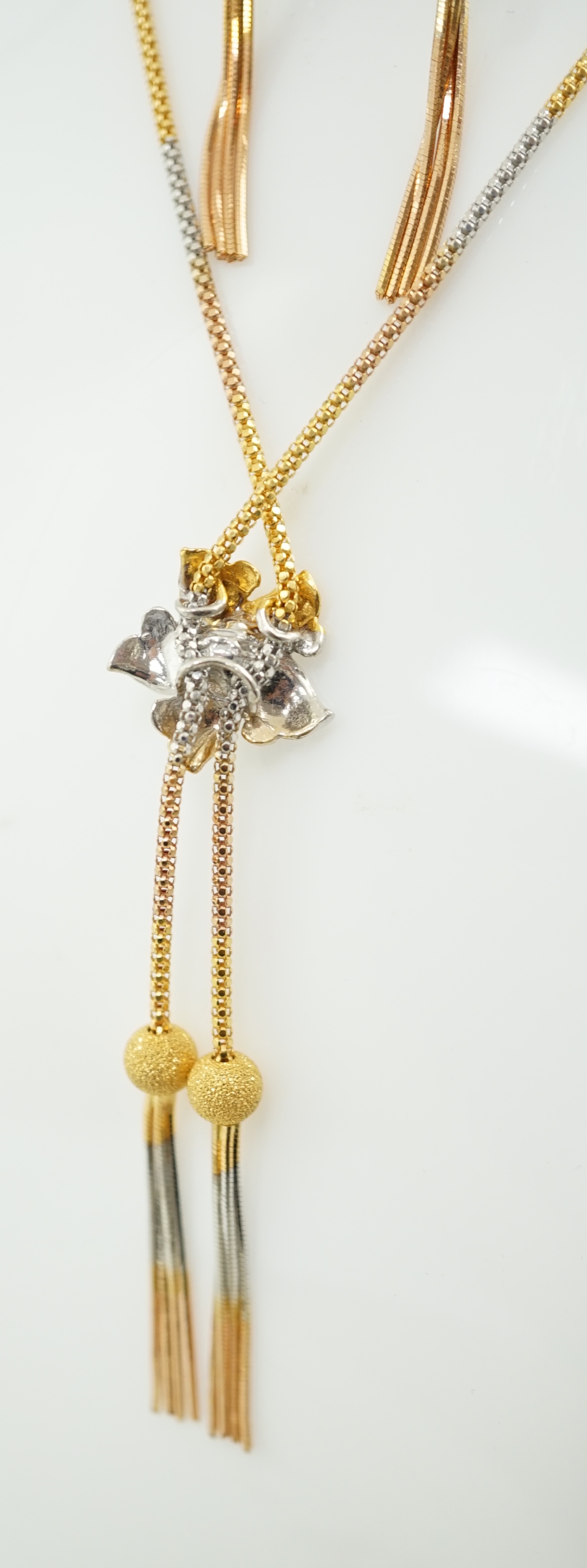 A recent Middle Eastern three colour 22k gold tassel drop necklace and pair of matching drop earrings